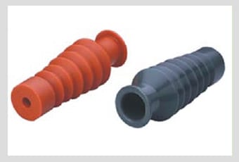 Two moulded bushing boots side by side, one red and one grey, each a ribbed conical elastomeric sleeve with an open throat